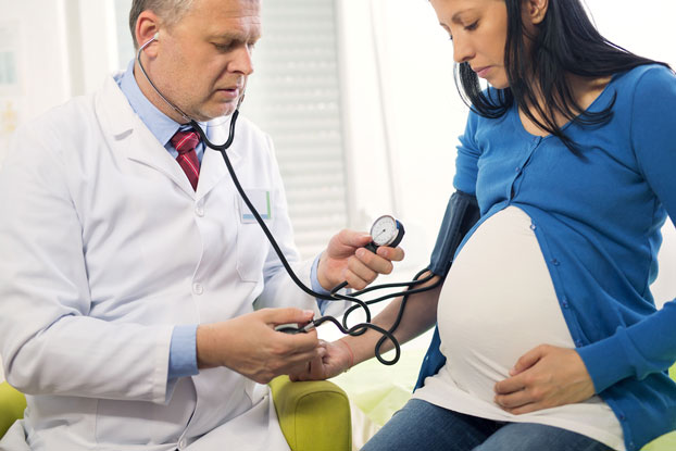 Obstetrician Monitoring Health of Mom & Baby During Pregnancy with Preeclampsia