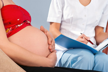 Obstetrician Providing Routine Prenatal Care to Pregnant Woman