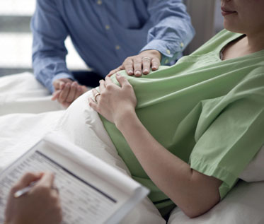 Couple Consulting with Obstetrician About C-Section
