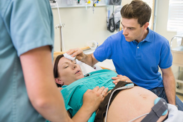 Nurse Checking on Woman in Labor