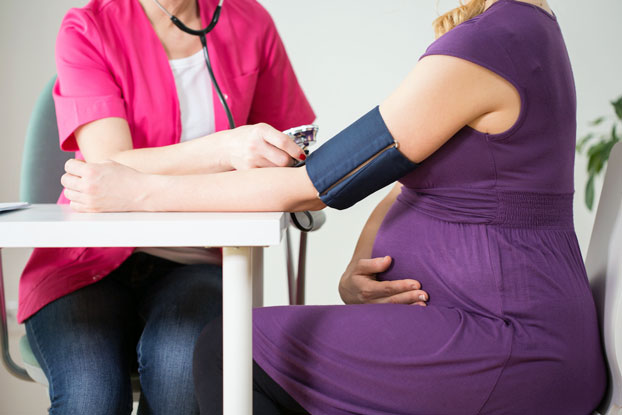 Woman with High-Risk Pregnancy Getting Blood Pressure Test